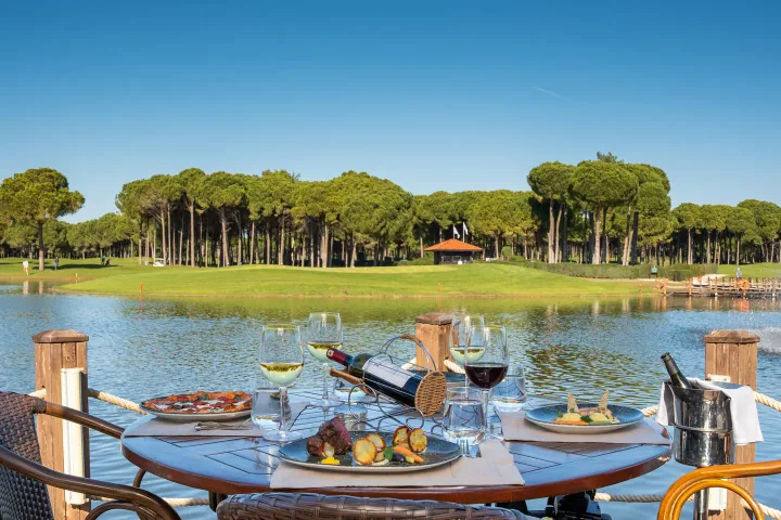 Birdie Bar terrace overlooking a lake and golf greens at Sueno Golf in Belek