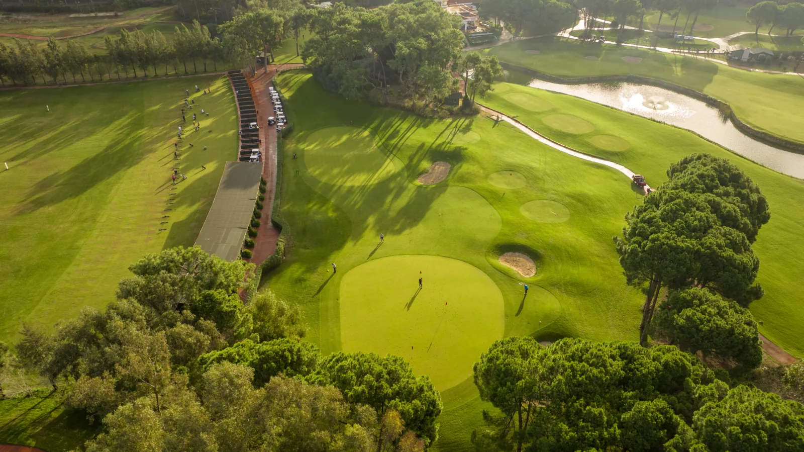 Aerial view of National Golf Club practice greens and pine-lined course